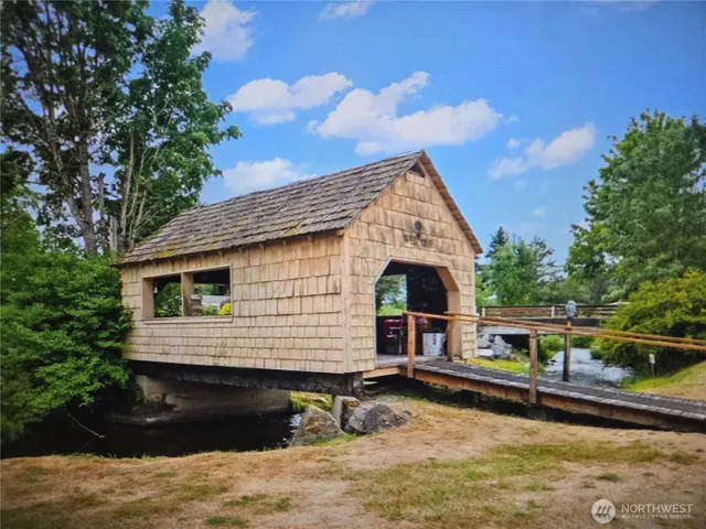 a front view of a house with swimming pool having outdoor seating