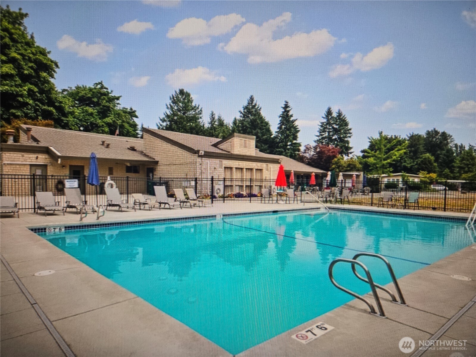 18425 Northeast 95th Street, Unit 76 Redmond, WA 98052 - Photo 19 of 20 a front view of a house with swimming pool having outdoor seating