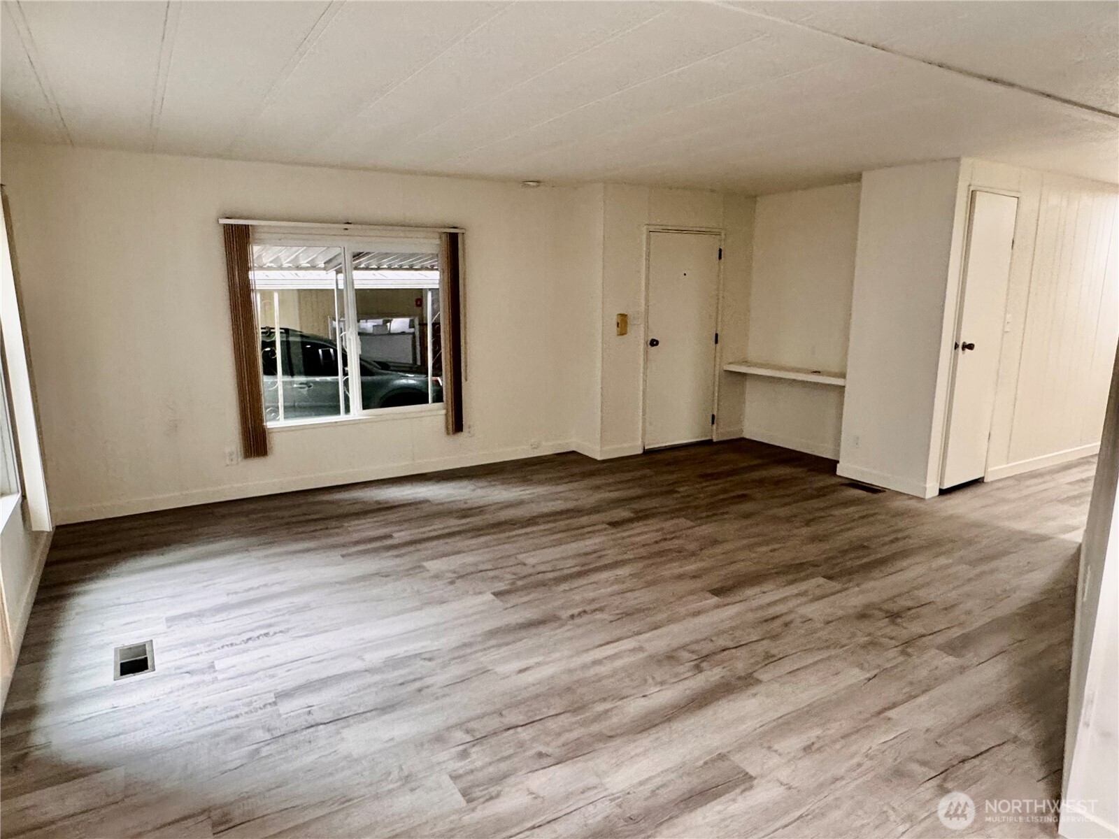 18425 Northeast 95th Street, Unit 76 Redmond, WA 98052 - Photo 4 of 20 a view of an empty room with wooden floor and windows