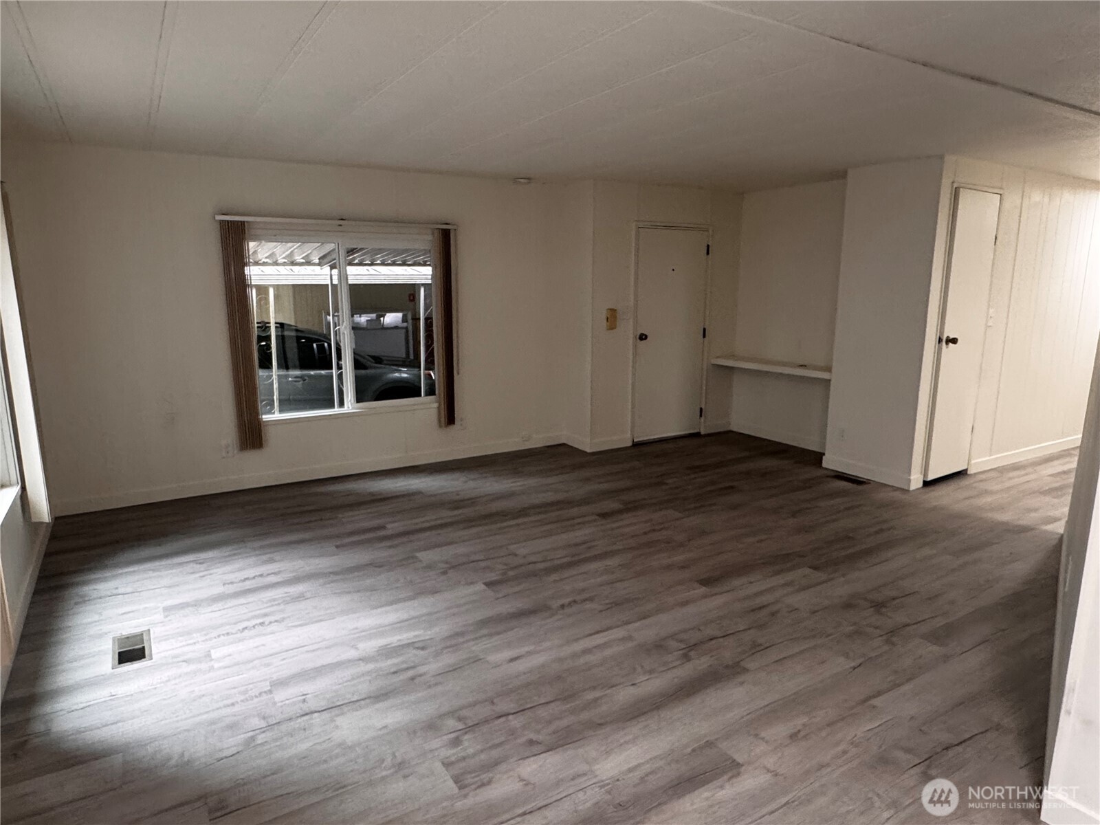 18425 Northeast 95th Street, Unit 76 Redmond, WA 98052 - Photo 6 of 20 an empty room with wooden floor and windows