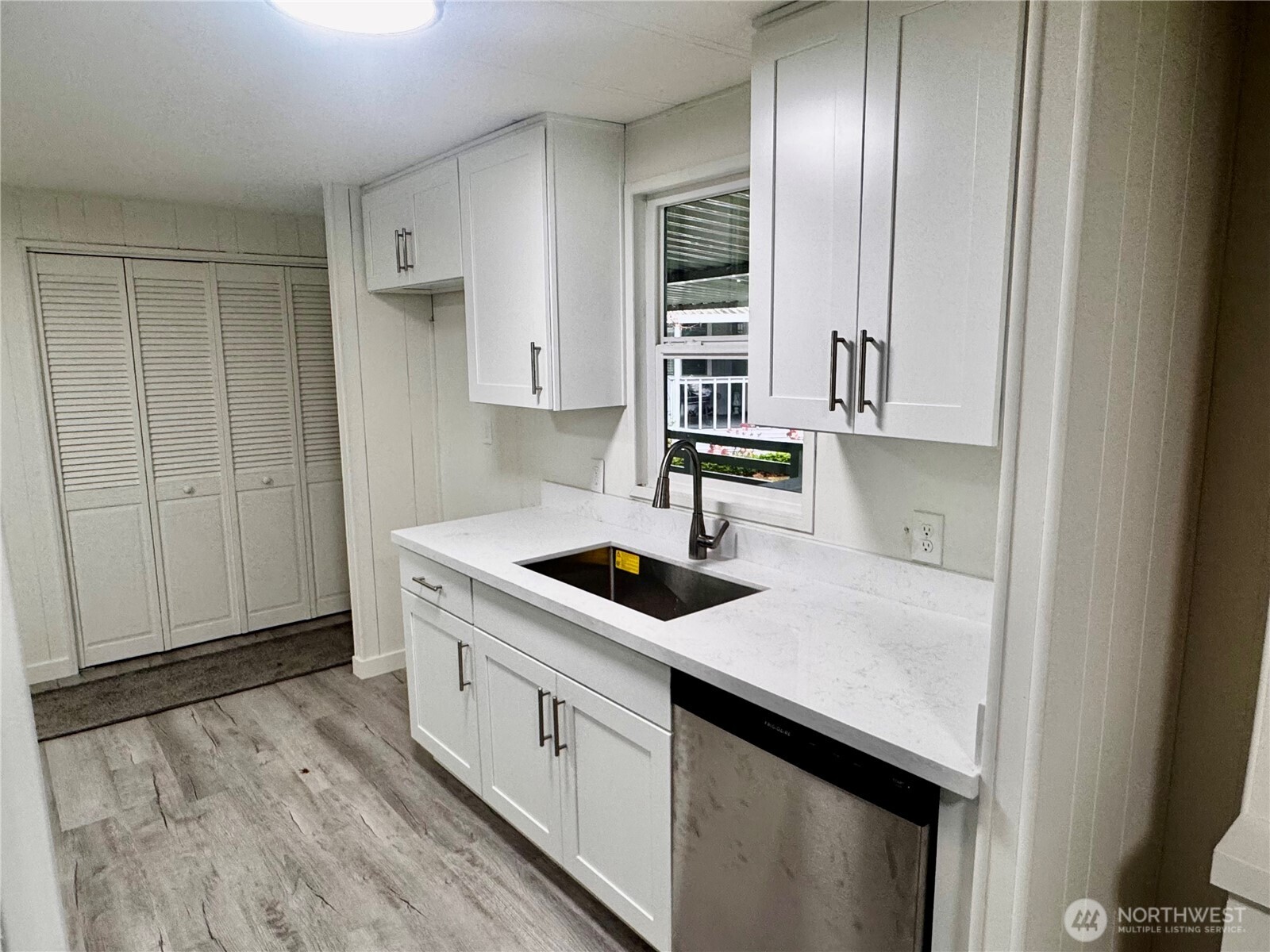 18425 Northeast 95th Street, Unit 76 Redmond, WA 98052 - Photo 7 of 20 a kitchen with stainless steel appliances granite countertop a sink stove and cabinets