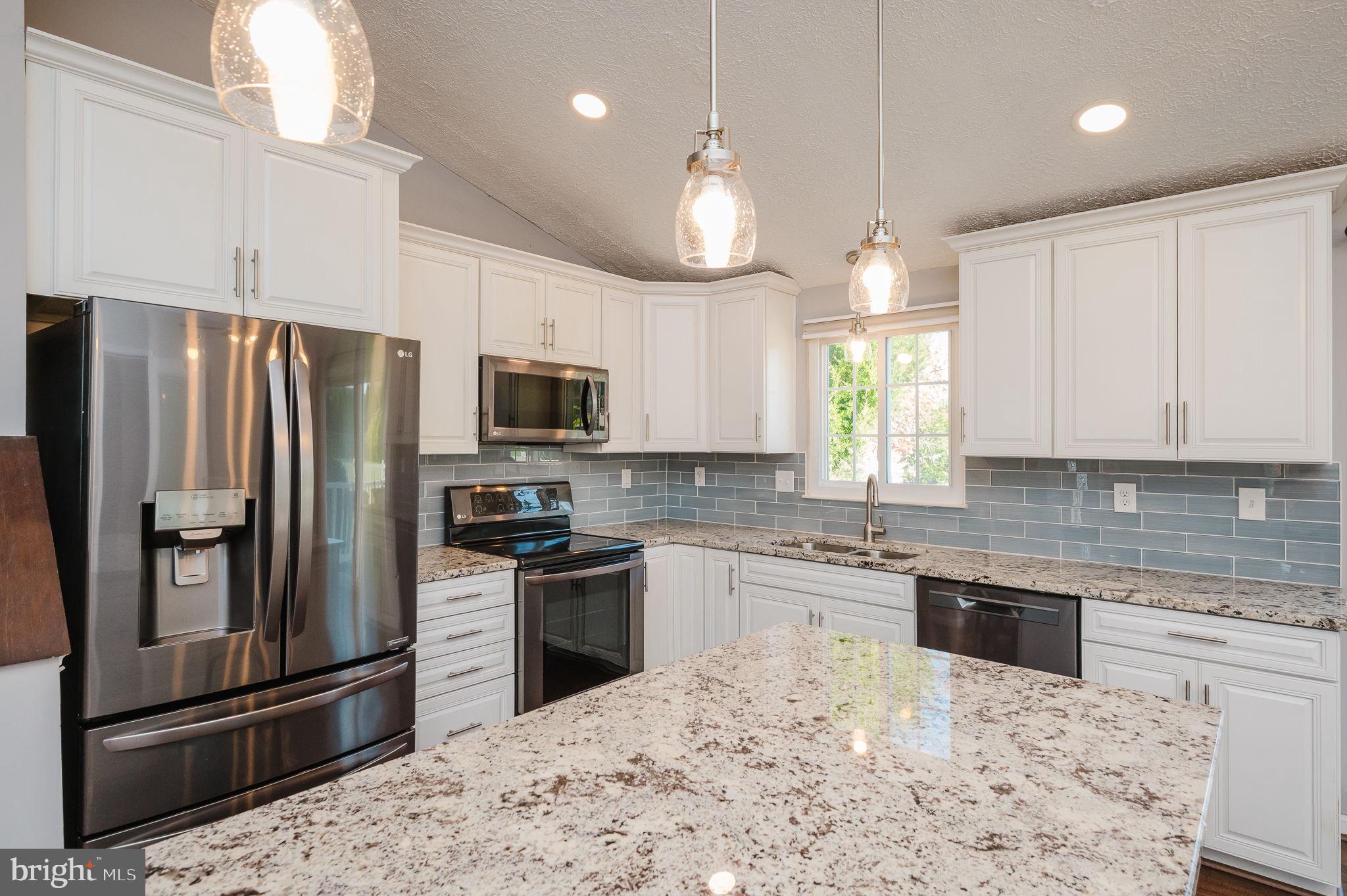 2601 Merrick Way Abingdon, MD 21009 - Photo 11 of 59 a kitchen with stainless steel appliances granite countertop a refrigerator a stove a sink dishwasher a oven with white cabinets and wooden floor