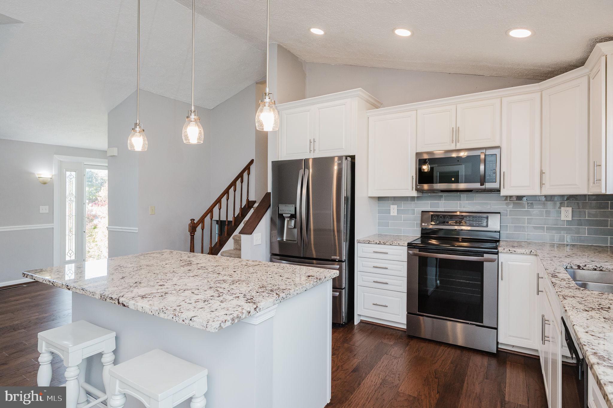 2601 Merrick Way Abingdon, MD 21009 - Photo 15 of 59 a kitchen with stainless steel appliances kitchen island granite countertop a stove a sink and a refrigerator