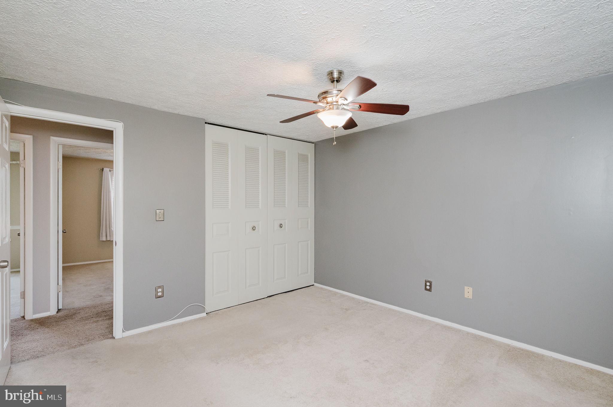 2601 Merrick Way Abingdon, MD 21009 - Photo 25 of 59 an empty room with a chandelier fan and kitchen view