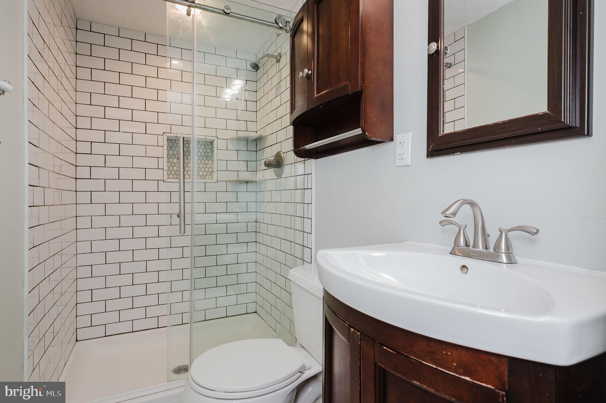 2601 Merrick Way Abingdon, MD 21009 - Photo 26 of 59 a bathroom with a sink a toilet and mirror