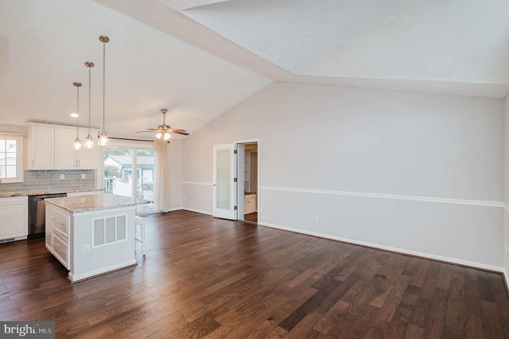 2601 Merrick Way Abingdon, MD 21009 - Photo 3 of 59 a view of an empty room with wooden floor and a kitchen
