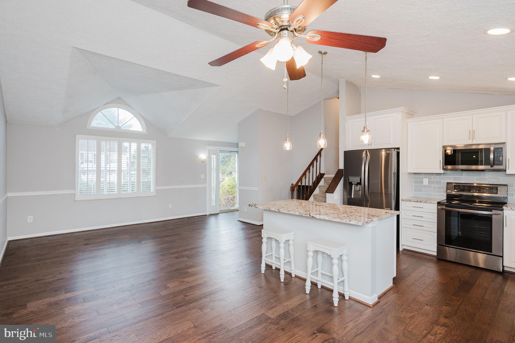 2601 Merrick Way Abingdon, MD 21009 - Photo 9 of 59 an open kitchen with wooden floor and stainless steel appliances