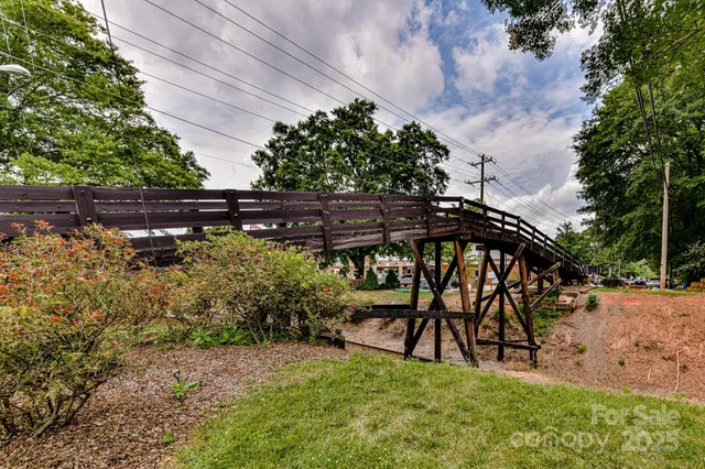 a view of a house with a patio and a yard