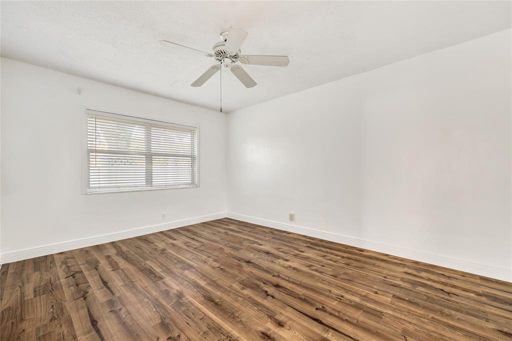 280 South Cypress Road, Unit 306 Pompano Beach, FL 33060 - Photo 11 of 17 wooden floor in an empty room with a window