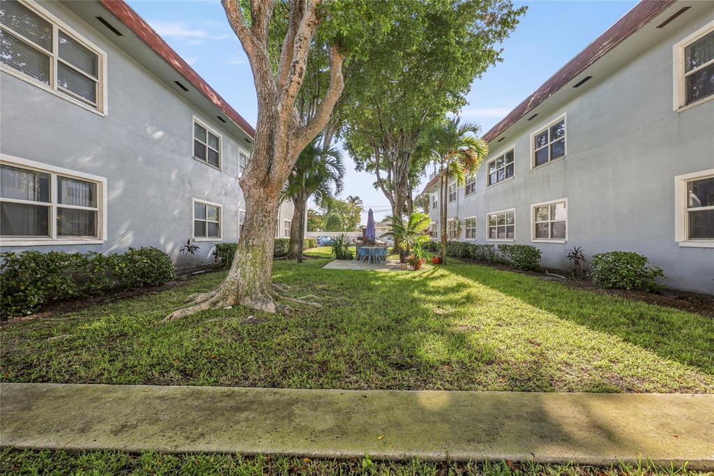 280 South Cypress Road, Unit 306 Pompano Beach, FL 33060 - Photo 16 of 17 a view of a yard in front of a building