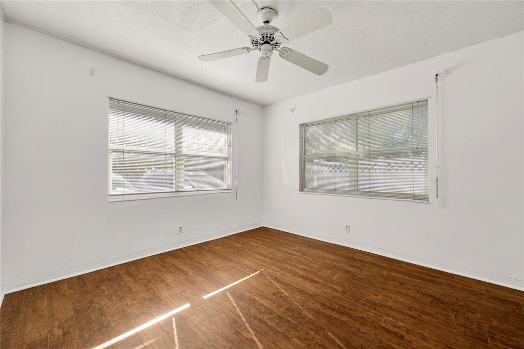 280 South Cypress Road, Unit 306 Pompano Beach, FL 33060 - Photo 8 of 17 a view of an empty room with a window and wooden floor
