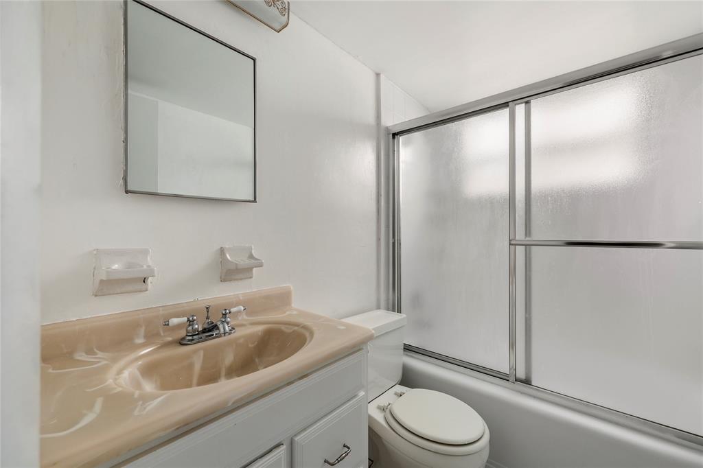 280 South Cypress Road, Unit 306 Pompano Beach, FL 33060 - Photo 10 of 17 a bathroom with a sink a toilet and a mirror