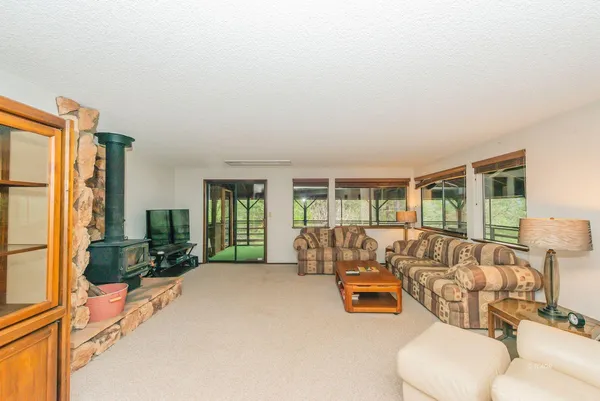 a bedroom with furniture and large windows