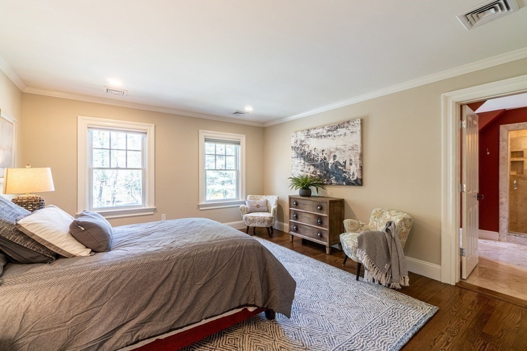 99 Country Way Needham, MA 02492 - Photo 27 of 42 a bedroom with a bed wooden floor and windows