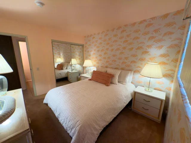 a bedroom with a bed and a lamp