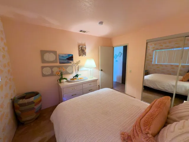 a bedroom with a bed and dresser