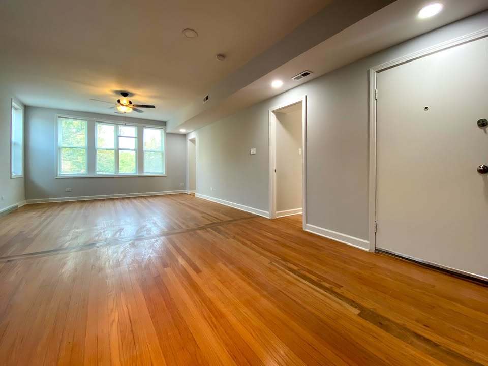 619 East Groveland Park, Unit 2W Chicago, IL 60616 - Photo 13 of 17 an empty room with wooden floor and windows