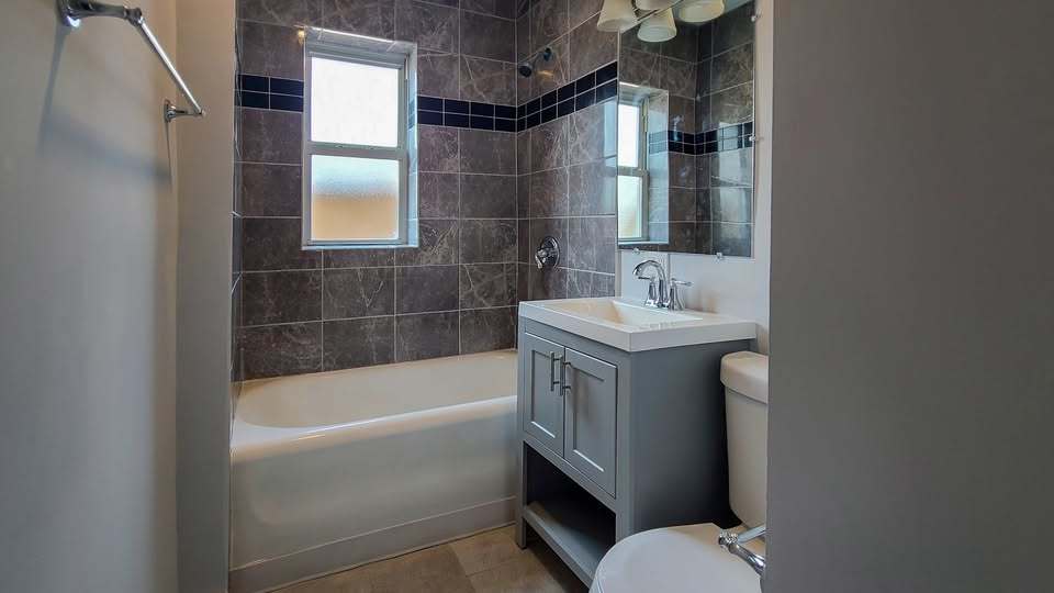 619 East Groveland Park, Unit 2W Chicago, IL 60616 - Photo 6 of 17 a bathroom with a sink a toilet and shower