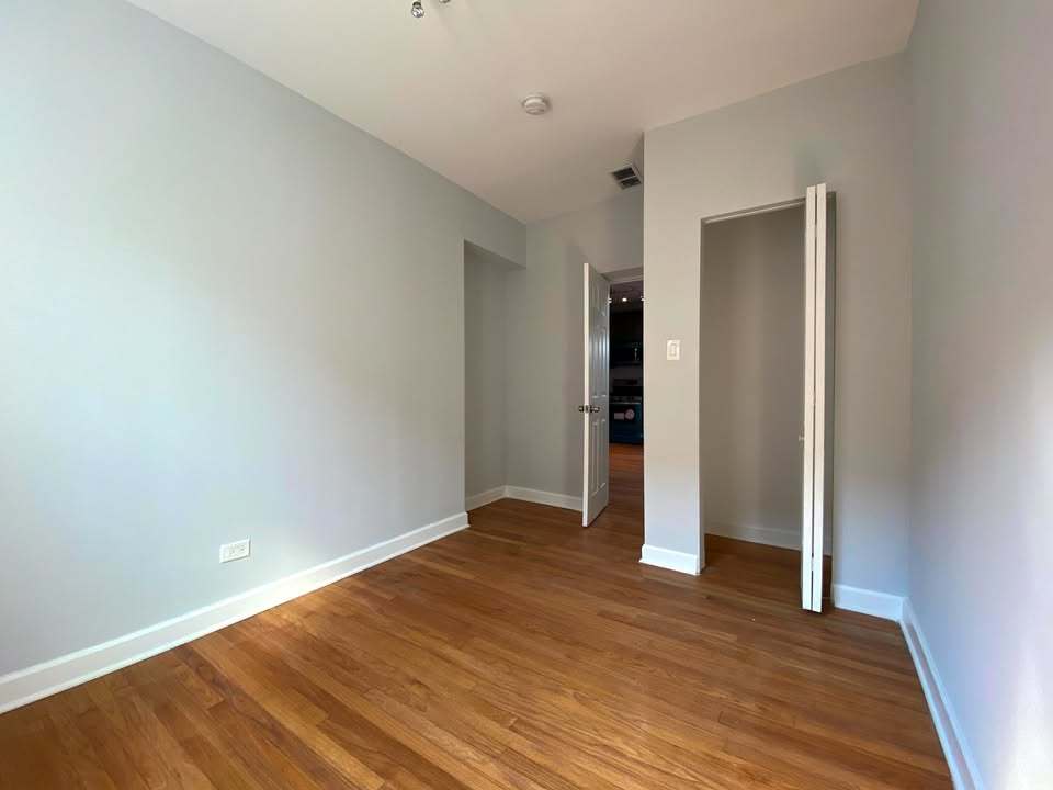 619 East Groveland Park, Unit 2W Chicago, IL 60616 - Photo 10 of 17 a view of an empty room with wooden floor and closet