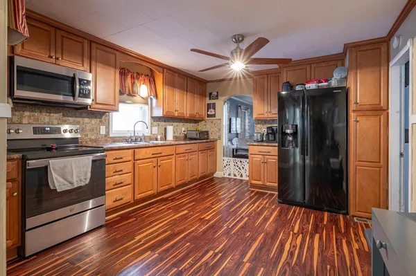 a kitchen with stainless steel appliances a refrigerator stove and sink