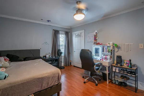a bedroom with a bed and a chair