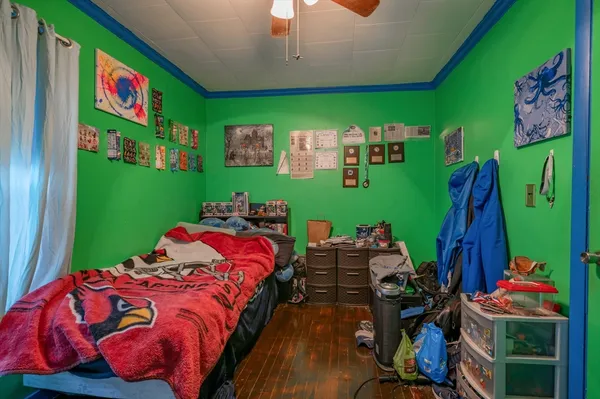 a bed sitting in a bedroom next to a window