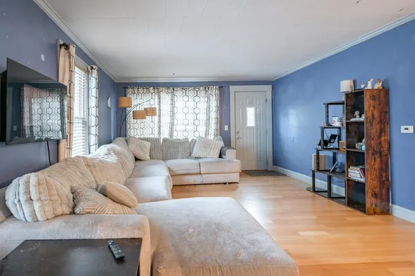 a living room with furniture and a book shelf