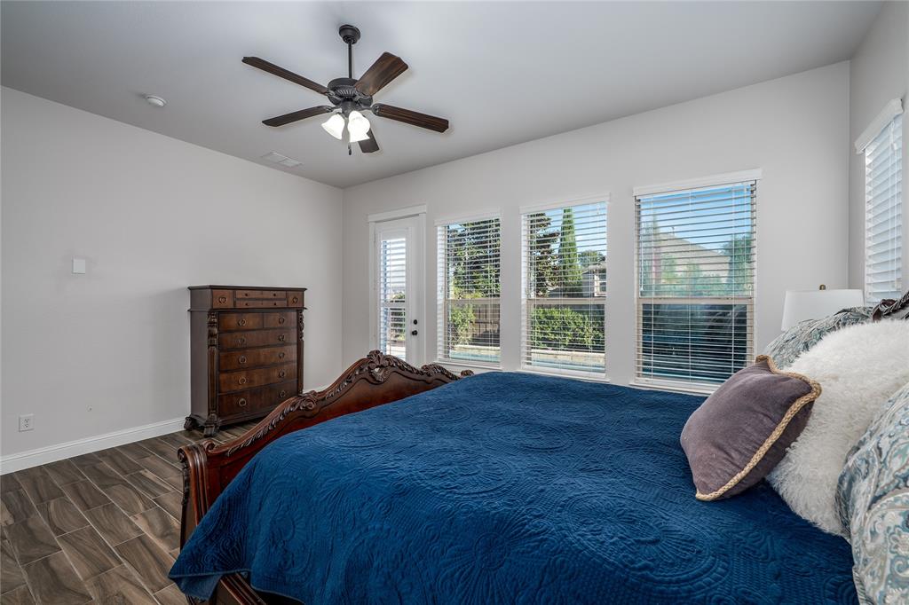 309 Bachman Creek Drive McKinney, TX 75072 - Photo 14 of 37 a bed sitting in a bedroom next to a window