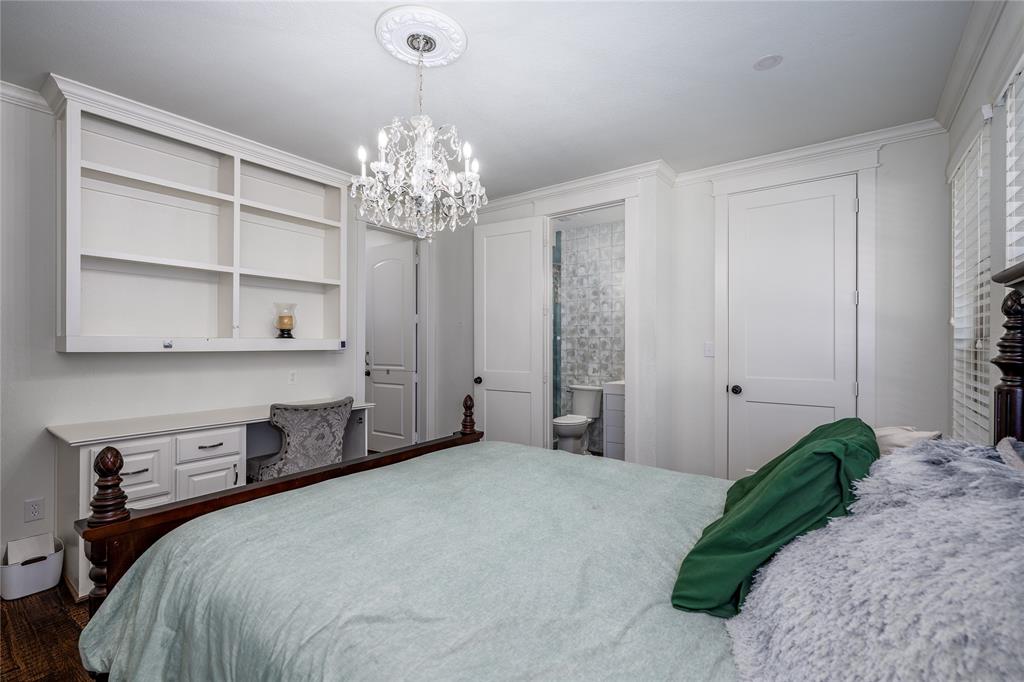 309 Bachman Creek Drive McKinney, TX 75072 - Photo 20 of 37 a bedroom with a bed and a chandelier