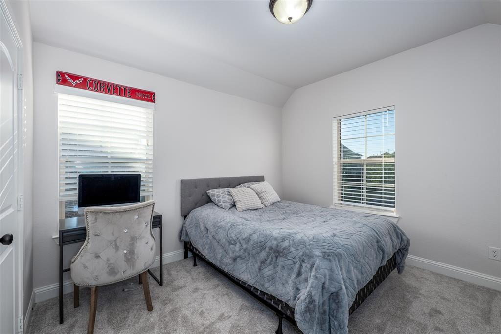 309 Bachman Creek Drive McKinney, TX 75072 - Photo 25 of 37 a bedroom with a bed and a flat screen tv