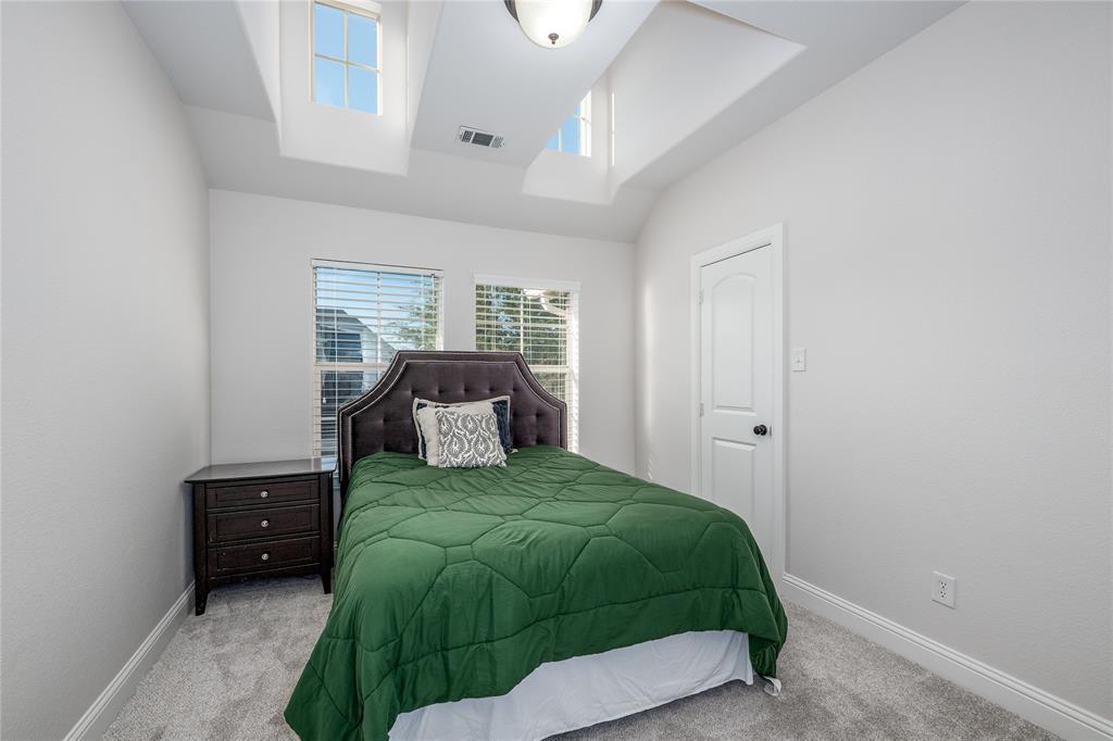 309 Bachman Creek Drive McKinney, TX 75072 - Photo 27 of 37 a bedroom with a bed and a window