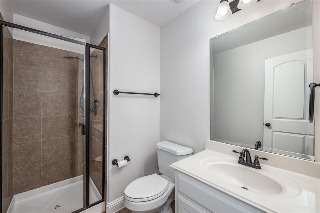 309 Bachman Creek Drive McKinney, TX 75072 - Photo 29 of 37 a bathroom with a sink toilet and shower
