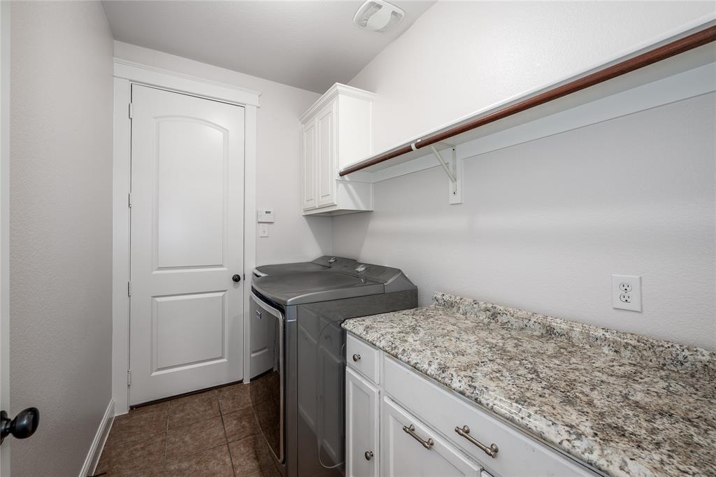 309 Bachman Creek Drive McKinney, TX 75072 - Photo 31 of 37 a kitchen with a stove and a refrigerator
