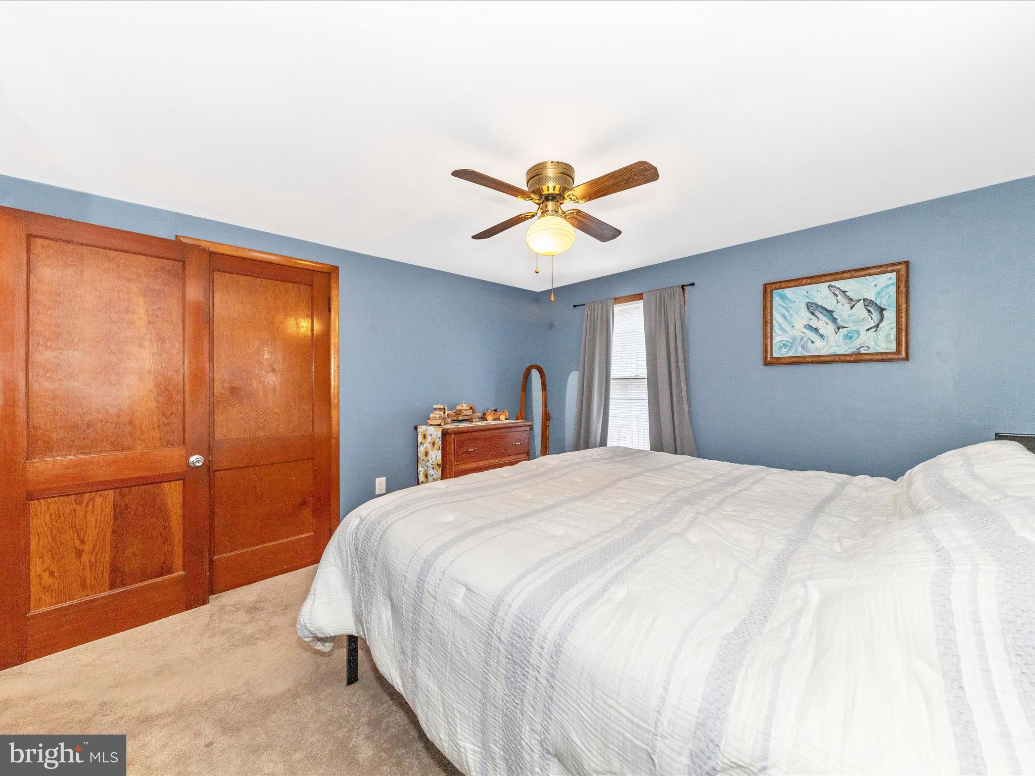 14021 Broadfording Church Road Hagerstown, MD 21740 - Photo 17 of 46 a bedroom with a large bed and a chandelier