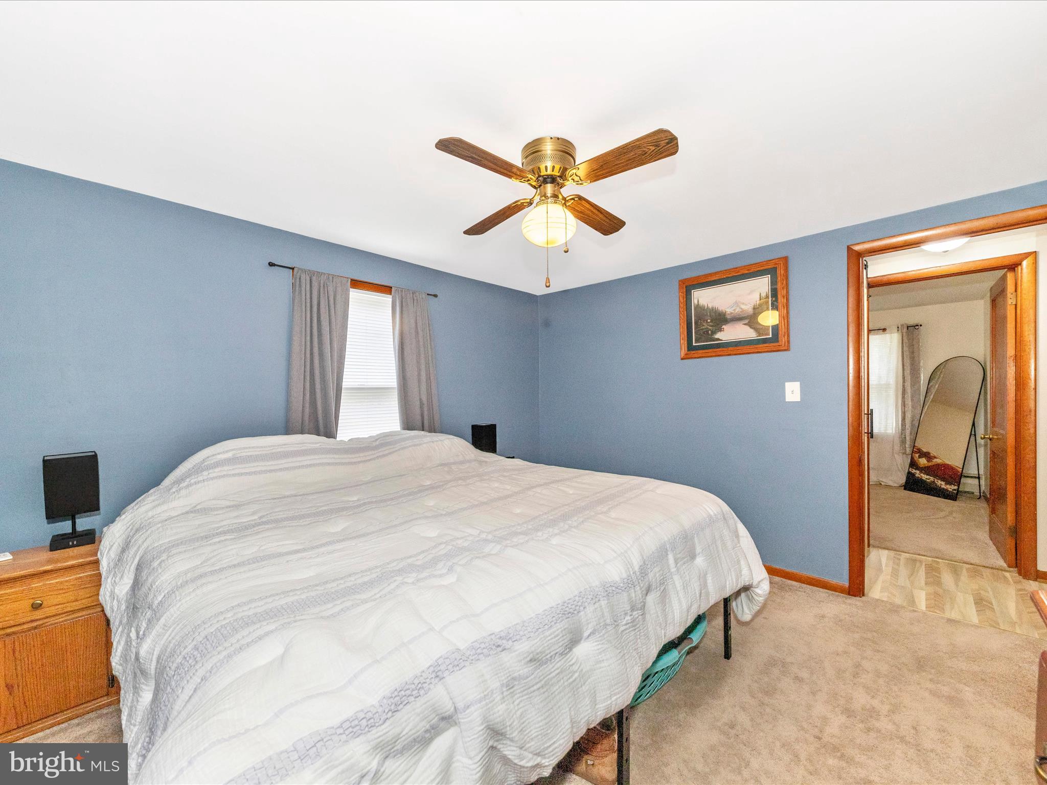 14021 Broadfording Church Road Hagerstown, MD 21740 - Photo 18 of 46 a bedroom with a bed and a chandelier