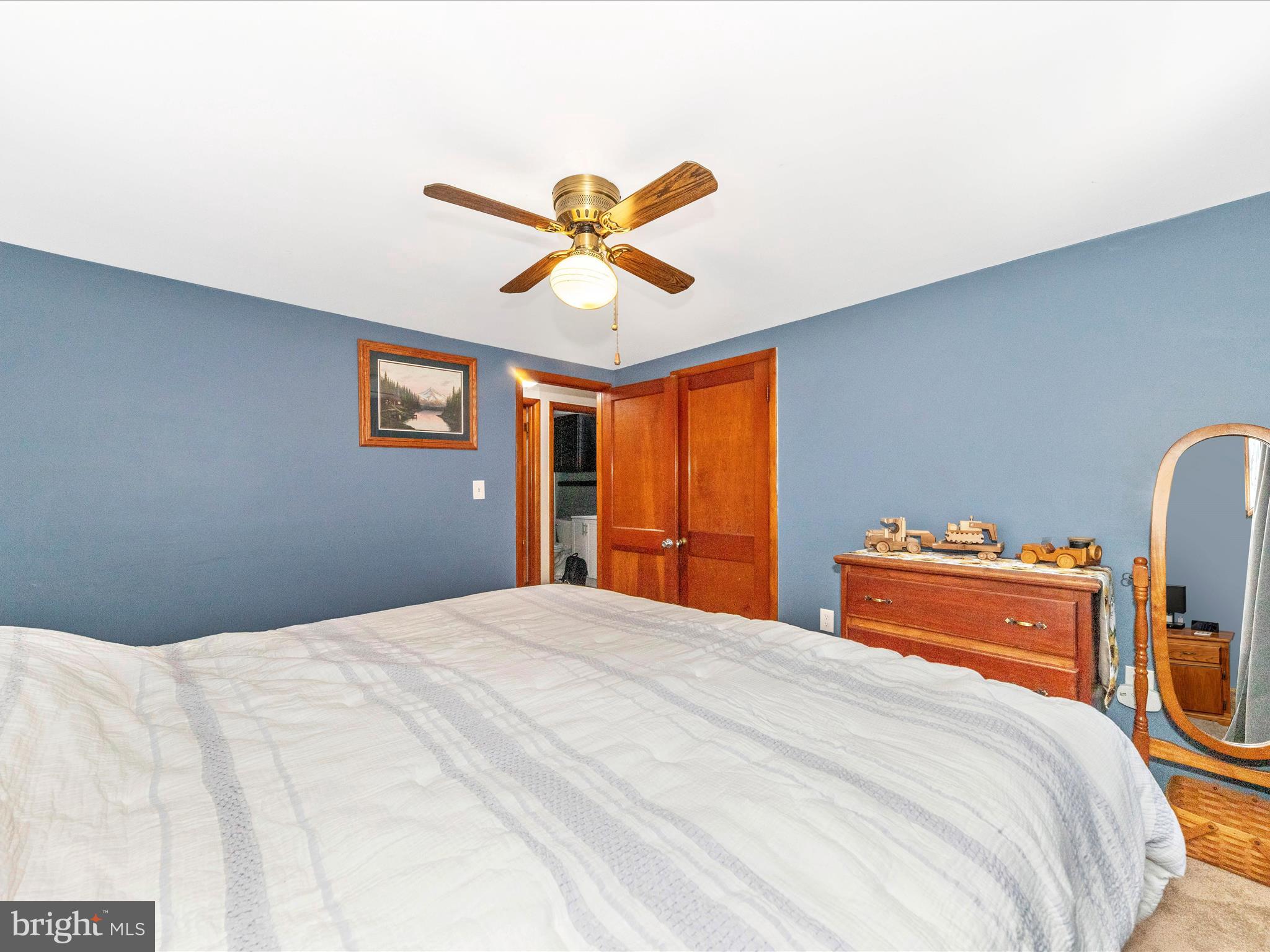 14021 Broadfording Church Road Hagerstown, MD 21740 - Photo 19 of 46 a bedroom with a bed and a chandelier