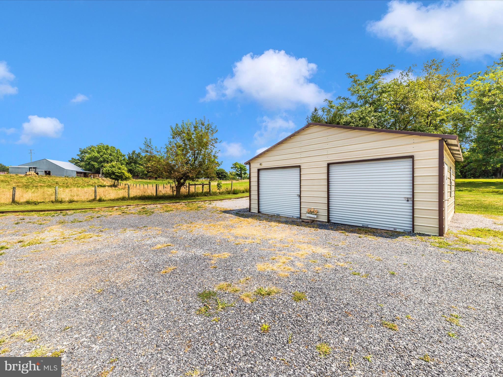 14021 Broadfording Church Road Hagerstown, MD 21740 - Photo 42 of 46 a front view of a house with a yard and garage