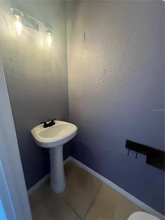a bathroom with a sink toilet