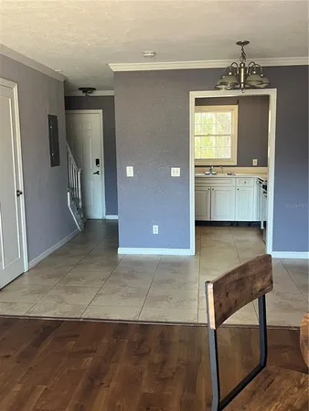 a view of a kitchen with a sink and a refrigerator