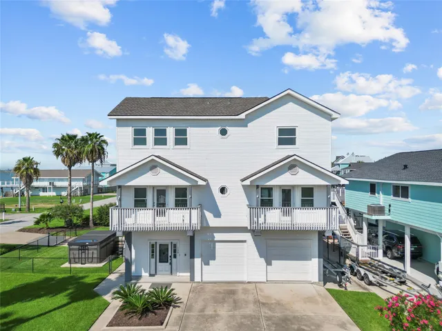 a front view of a house with a garden and plants