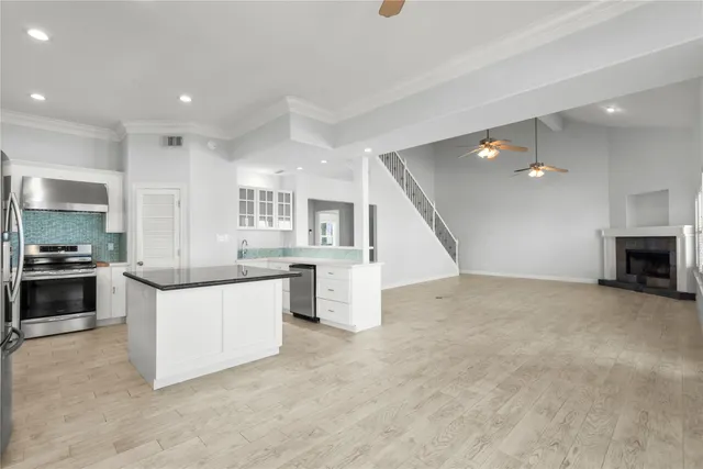a large kitchen with a stove a sink and a refrigerator