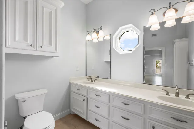 a bathroom with a toilet a sink and mirror