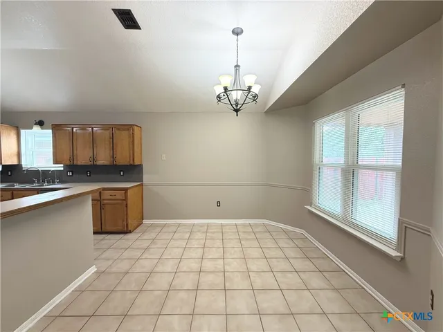 a view of a kitchen with a sink and cabinets