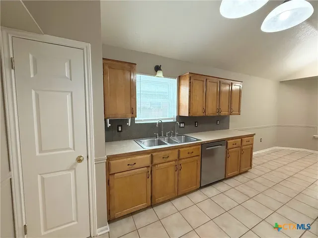 a large white kitchen with a sink