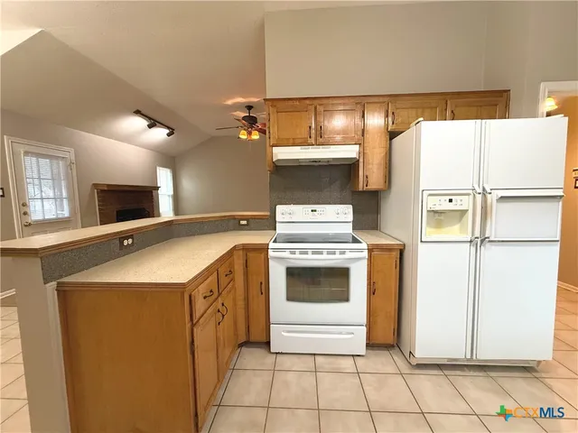 a kitchen with a stove and a refrigerator