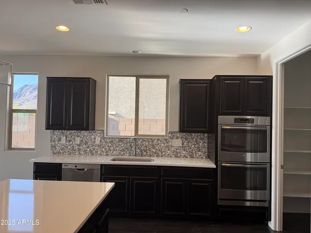 a kitchen with a refrigerator and a sink