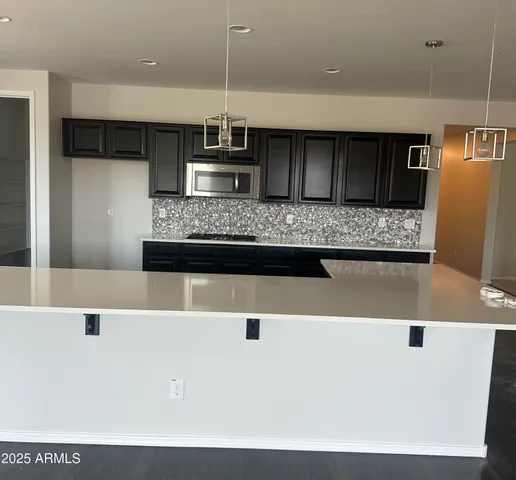a view of kitchen with stainless steel appliances cabinets