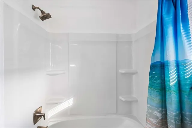 a bathroom with a shower and toilet
