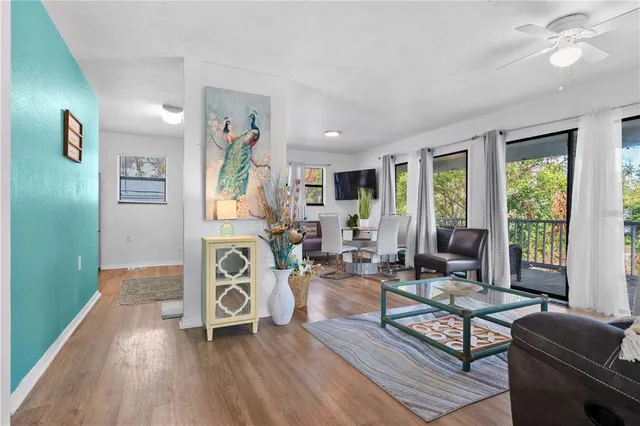 a living room with furniture and wooden floor