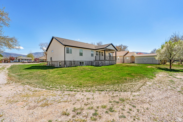 75 North 100th Street West Fillmore, UT 84631 - Photo 53 of 62 Rear view of house featuring a lawn